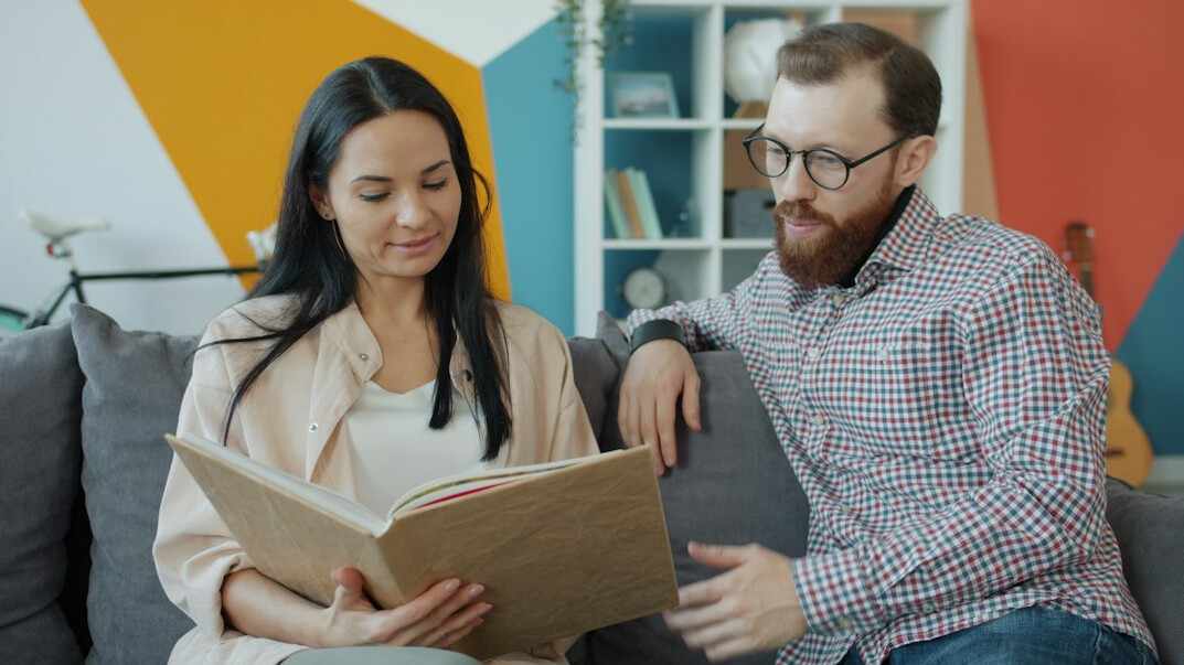 person reading book at home